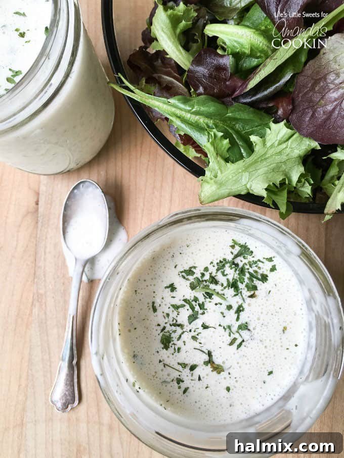 Try this delicious buttermilk ranch dressing recipe at home instead of buying another bottle. This homemade ranch dressing is creamy, delicious and fresh! Delicious buttermilk ranch dressing ready to be served on a salad, showcasing its creamy texture