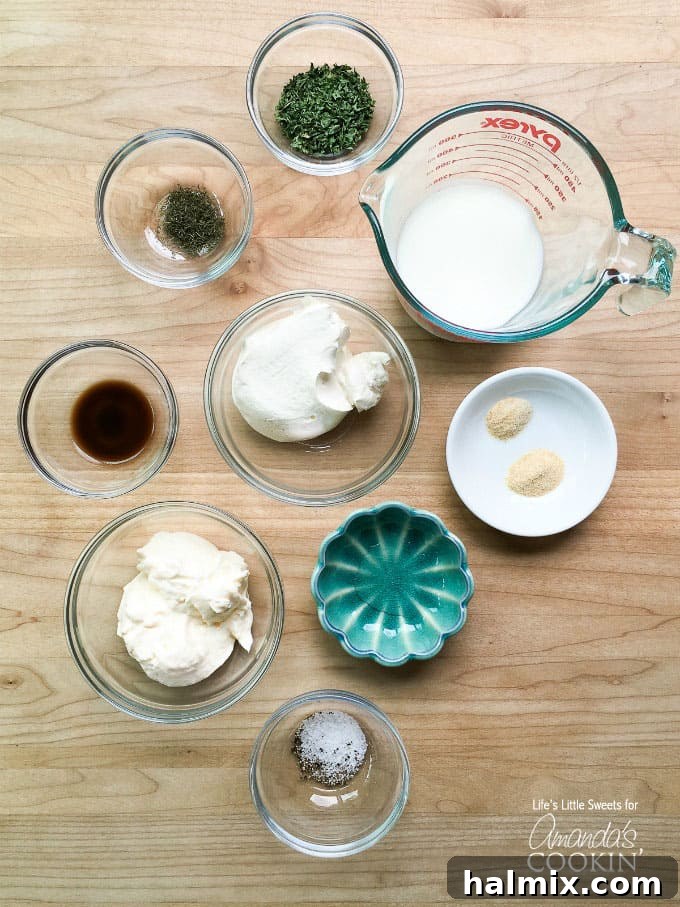Try this delicious buttermilk ranch dressing recipe at home instead of buying another bottle. This homemade ranch dressing is creamy, delicious and fresh! Various ingredients for buttermilk ranch dressing laid out on a wooden surface, including measuring spoons and fresh herbs