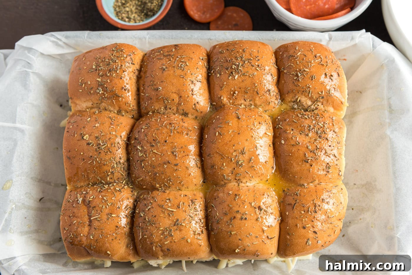 Cheesy Pizza Buns 11 Italian seasoning sprinkled over pizza sliders