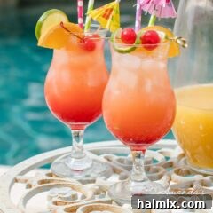 Island Elixir 12 Two glasses of rum punch poolside with a pitcher