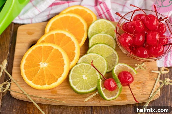 Island Elixir 5 Freshly sliced oranges and limes arranged with bright maraschino cherries on a wooden cutting board, ready to garnish tropical rum punch cocktails.
