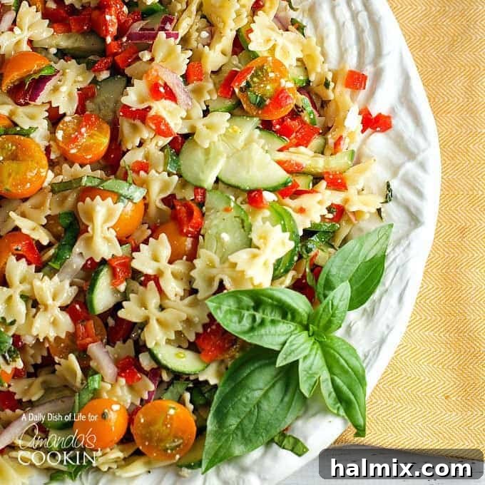Vibrant Summer Pasta Salad 3 Close-up shot of the summer vegetable pasta salad on a white plate, highlighting colorful ingredients.