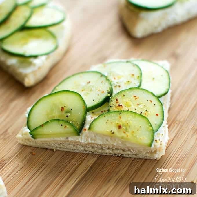 Perfectly Portioned for Any Gathering Platter of freshly made cucumber sandwiches, cut into wedges, ready to serve.