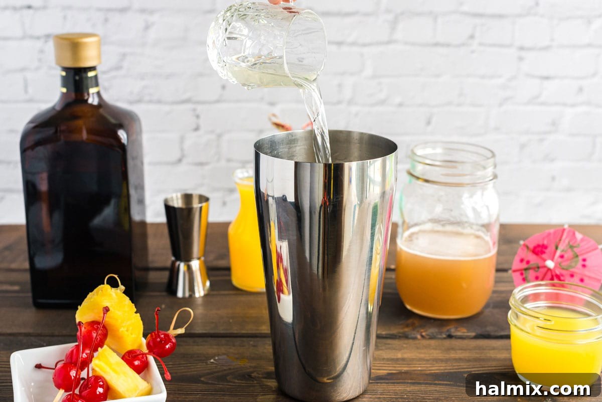 pouring rum into cocktail shaker