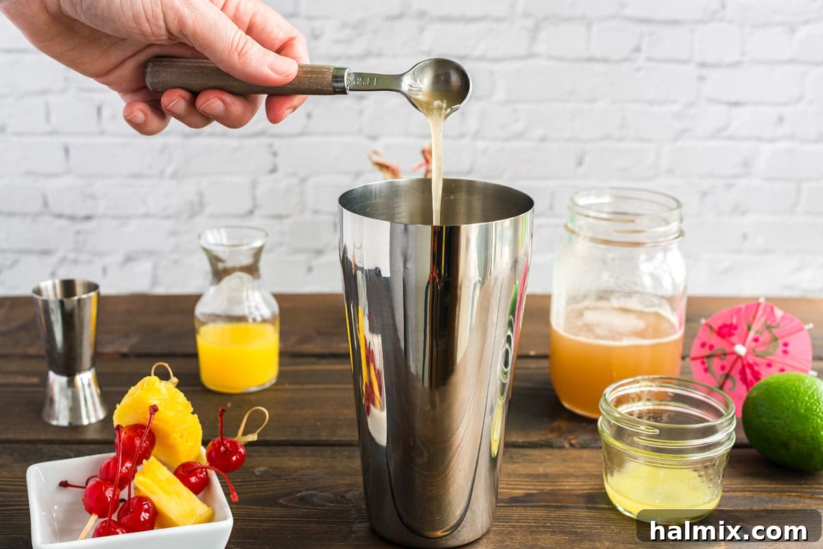 pouring orgeat syrup into cocktail shaker