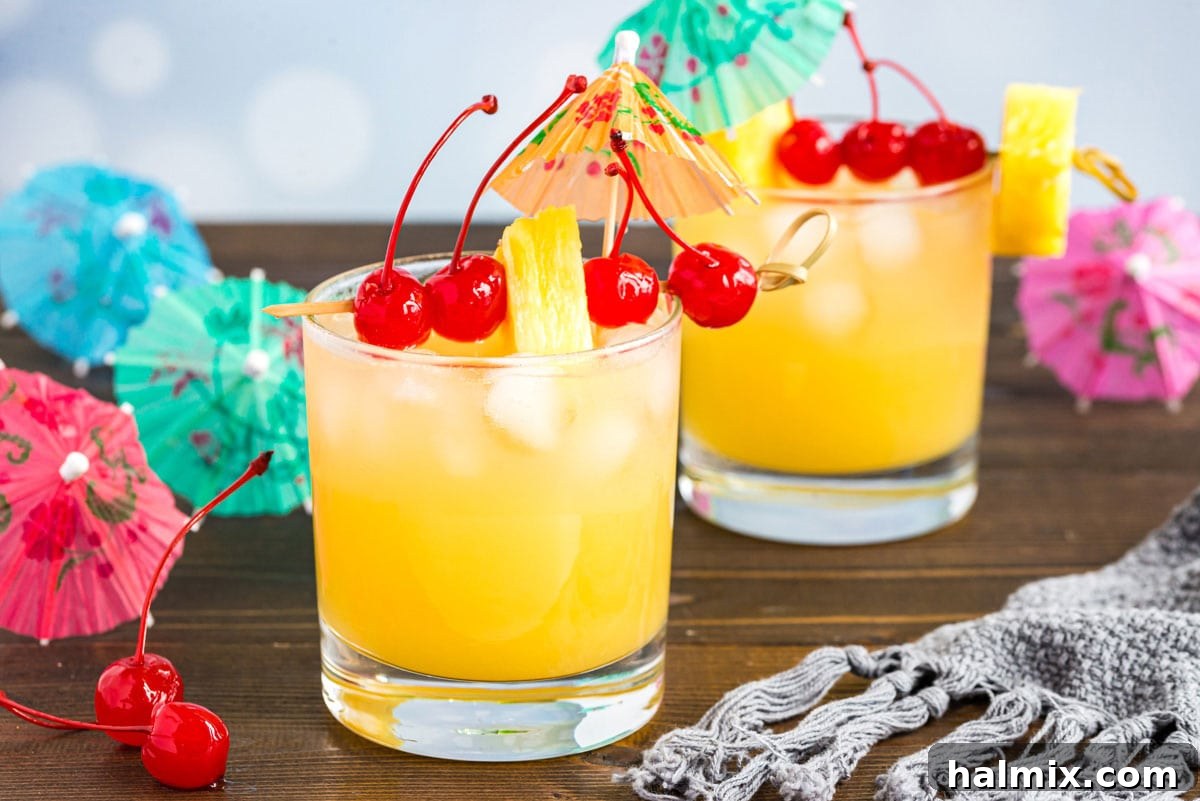 Mai Tai cocktail in a rock glass served with a cocktail umbrella