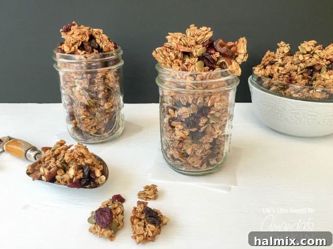 Multiple mason jars filled with autumn harvest fruit and nut granola, ready for storage or gifting.