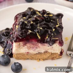 Close up photo of a slice of No Bake Blueberry Cheesecake on a plate