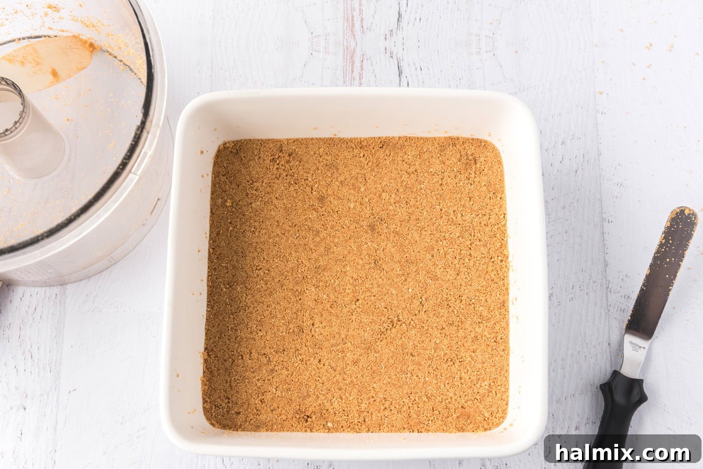 graham cracker crust in a square baking pan