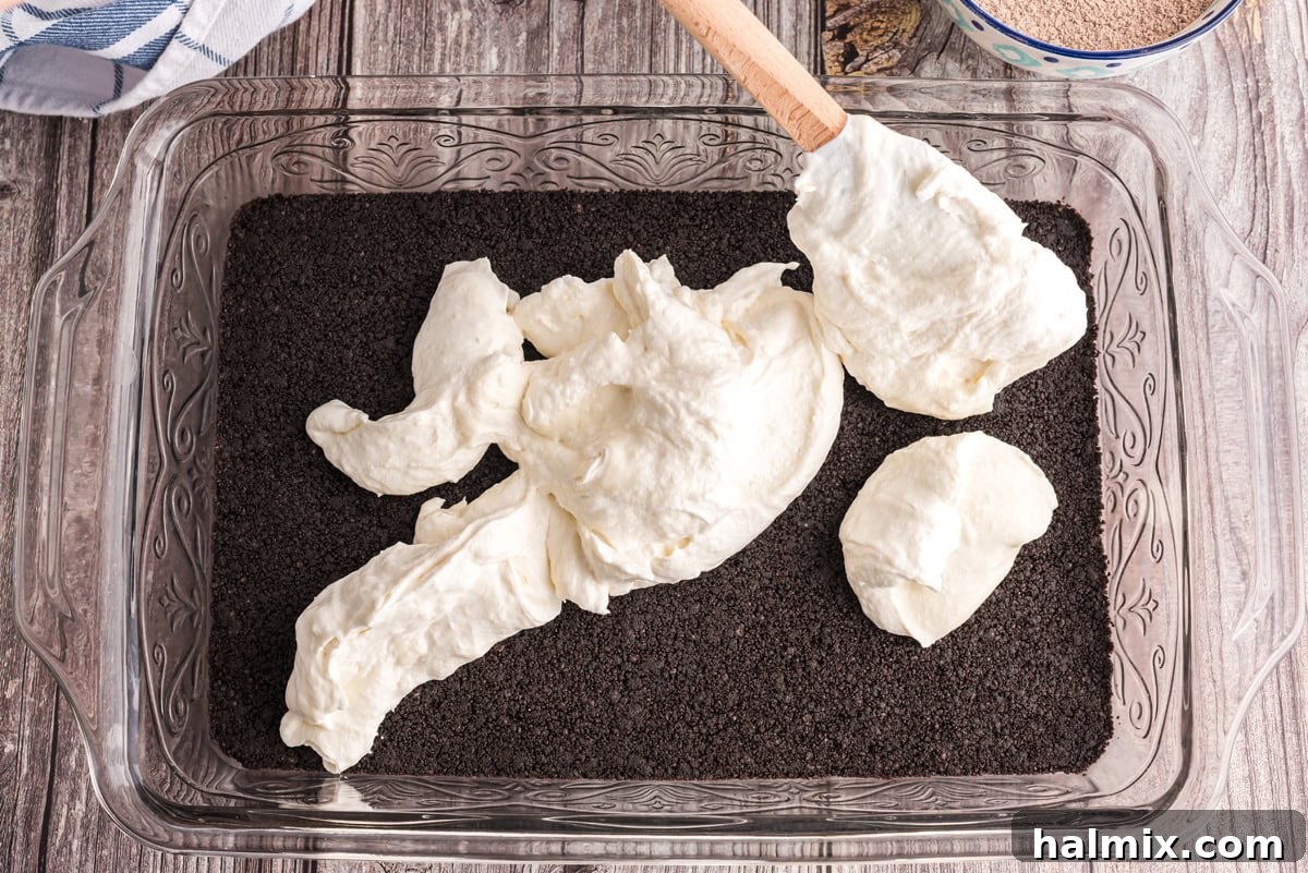 Cream cheese mixture spooned on top of the cookie crumb mixture