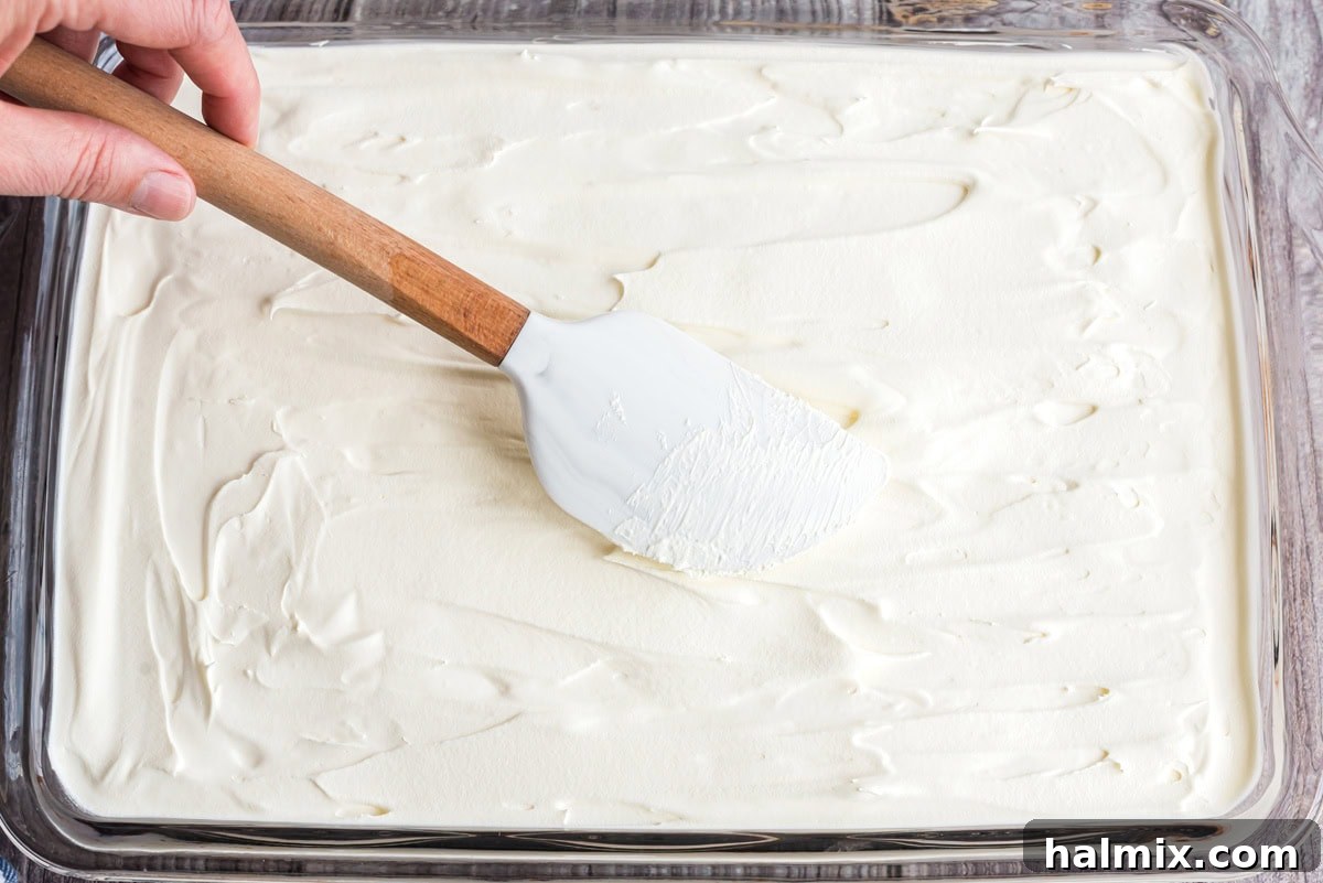 Cool whip spread over the pudding layer