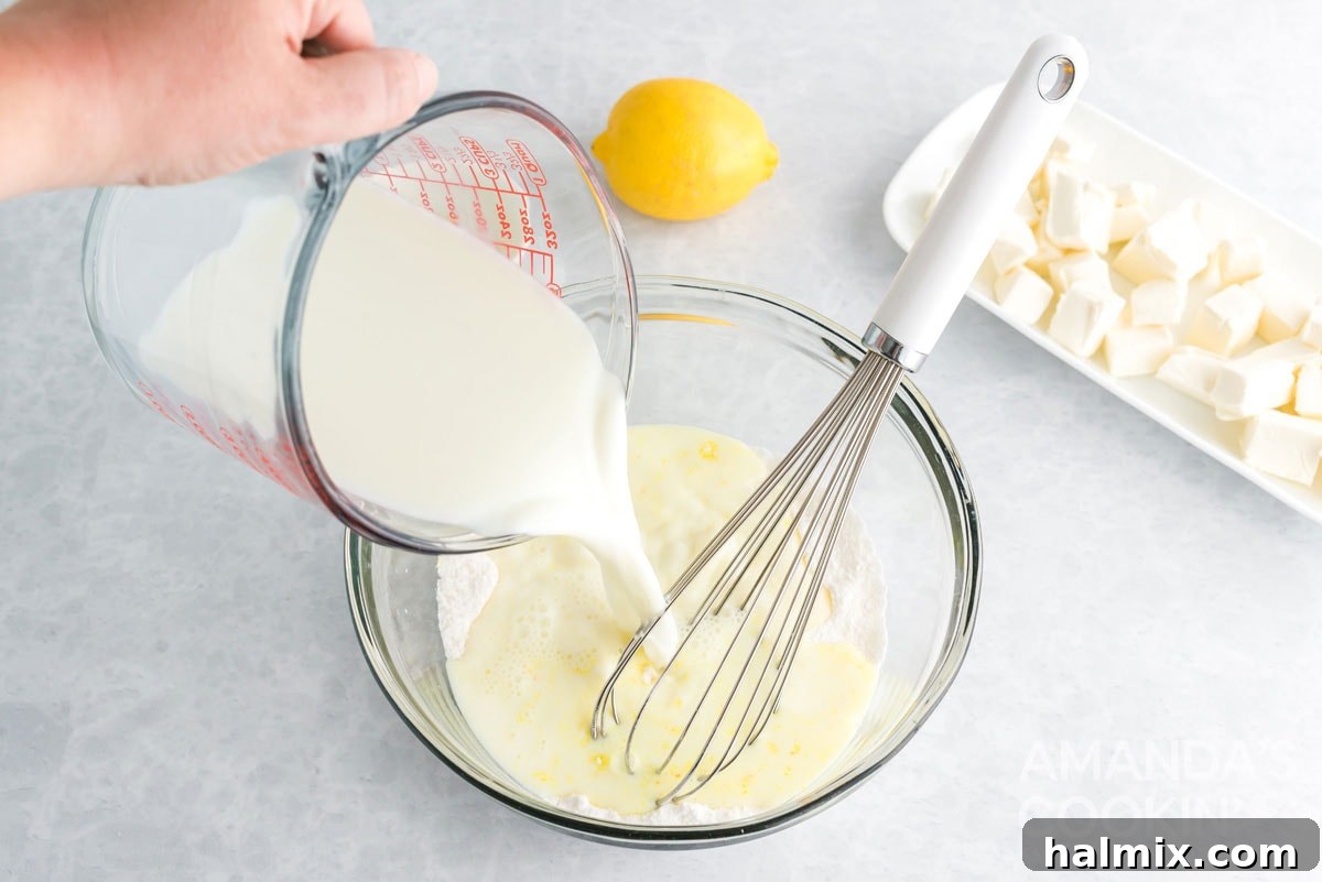 Pouring milk into a bowl with instant lemon pudding mix to prepare the filling.