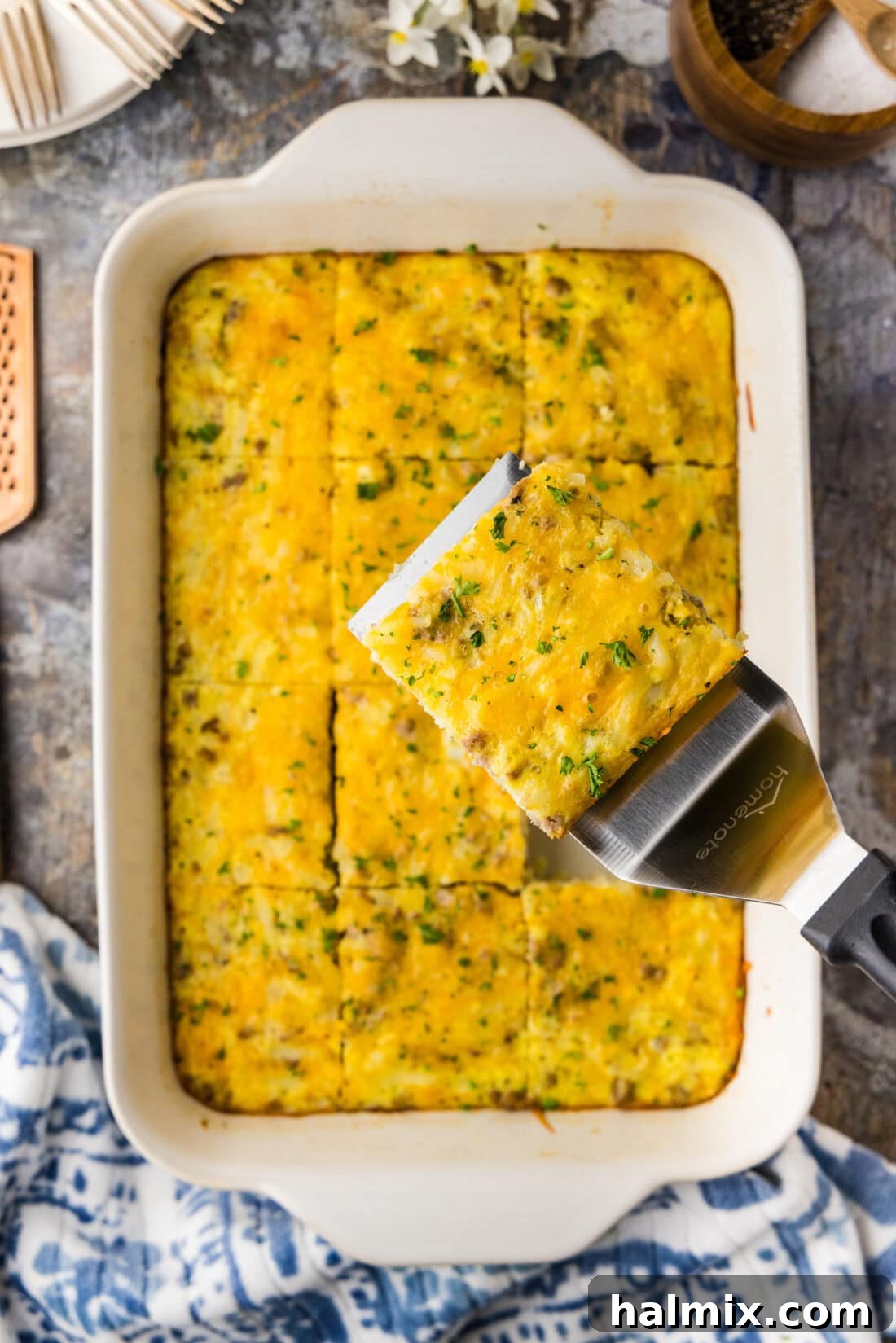 Savory Turkey Hash Brown Breakfast Bake 2 A close up of a white baking dish filled with fresh baked turkey hash brown breakfast casserole