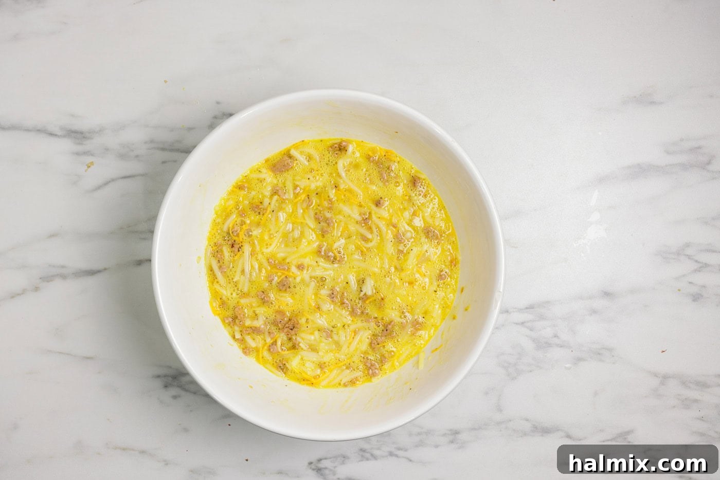 Savory Turkey Hash Brown Breakfast Bake 6 Turkey hash brown casserole ingredients mixed together in a bowl