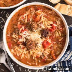Close up photo of a bowl of Italian Sausage Tomato Orzo Soup