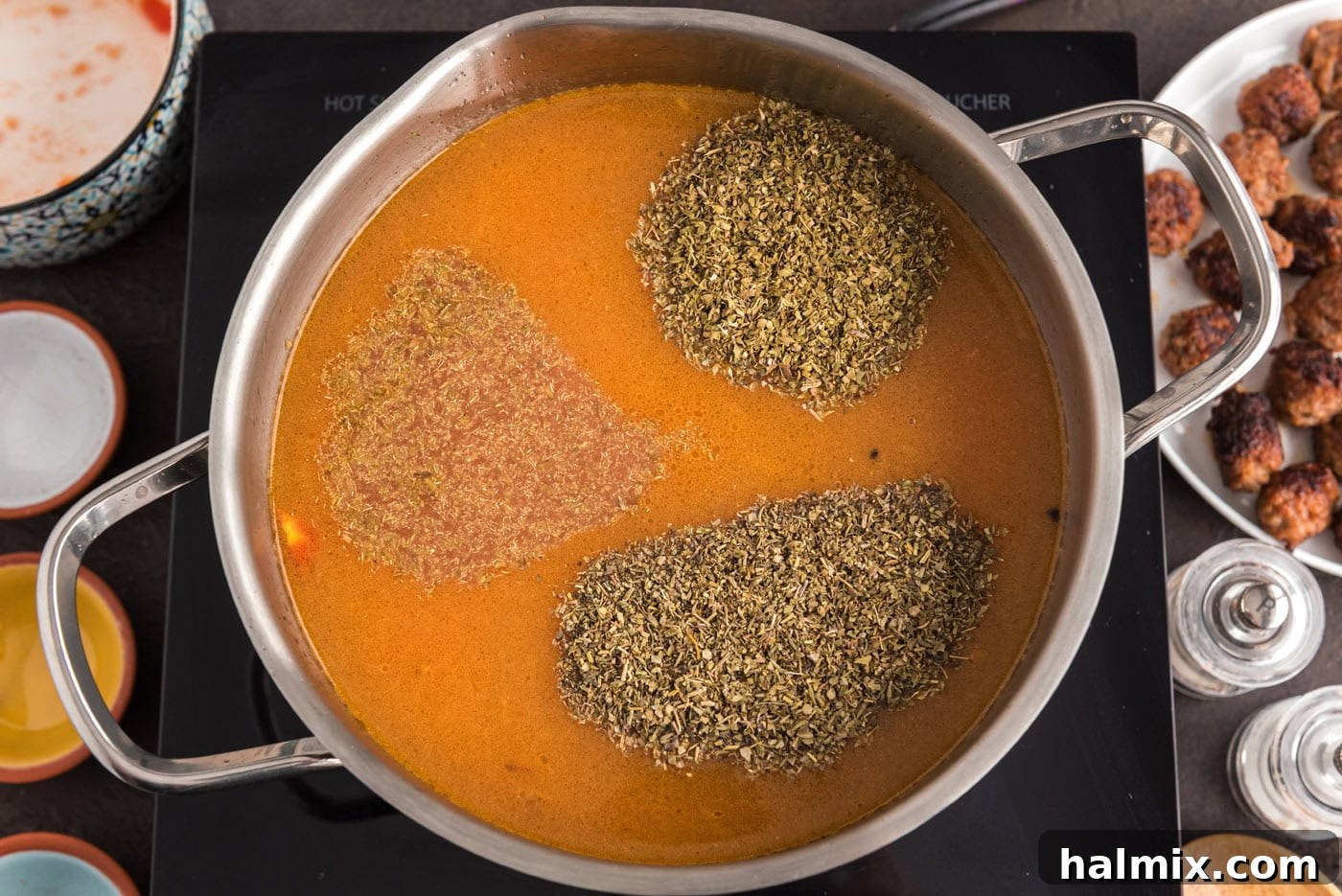 Savory Sausage Orzo Medley 9 seasonings added to soup in pot