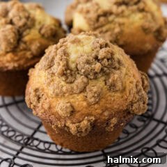 A close up of a cinnamon streusel muffin on a wire rack