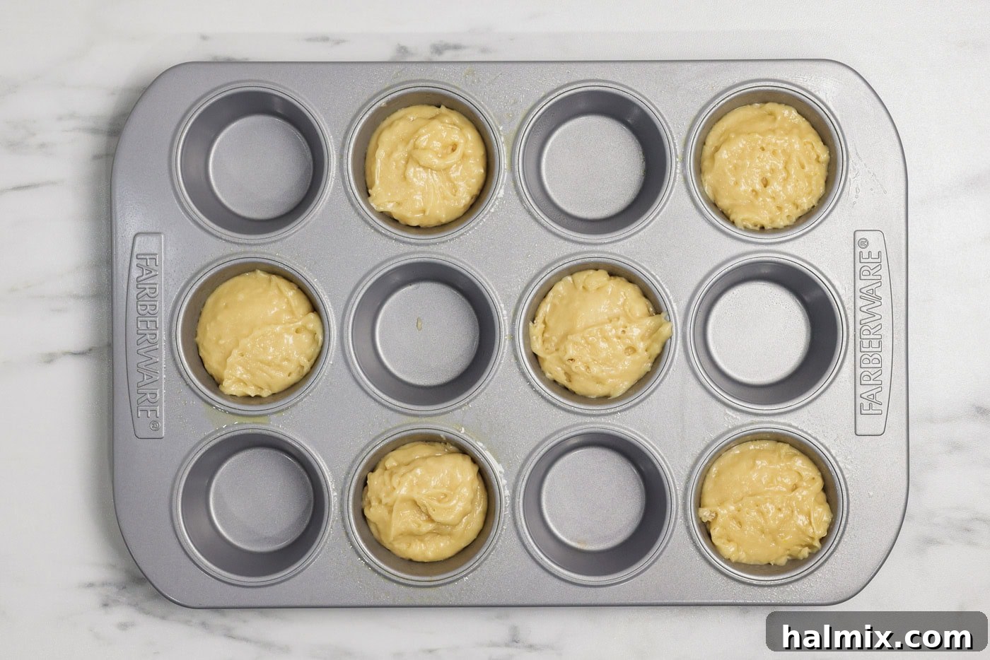 Muffin pan cavities filled with batter
