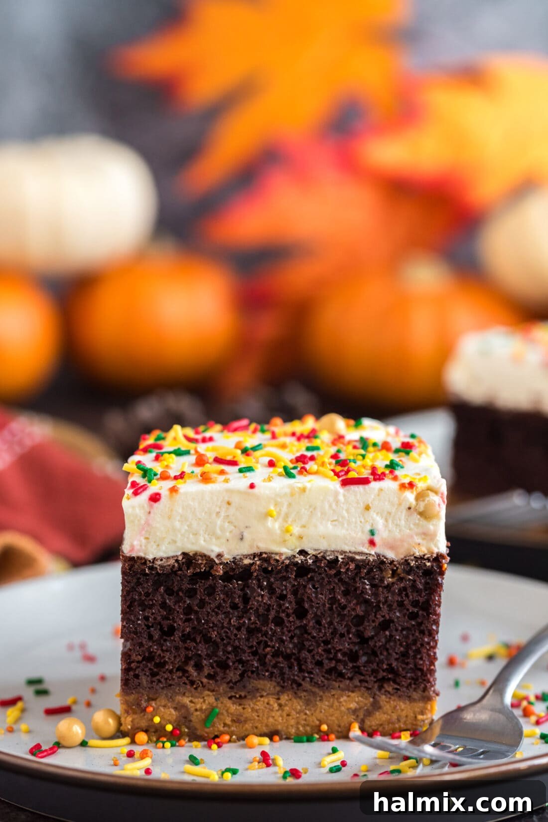 Enchanted Chocolate Pumpkin Cake 2 Square piece of Chocolate Pumpkin Magic Cake on a plate with a fork
