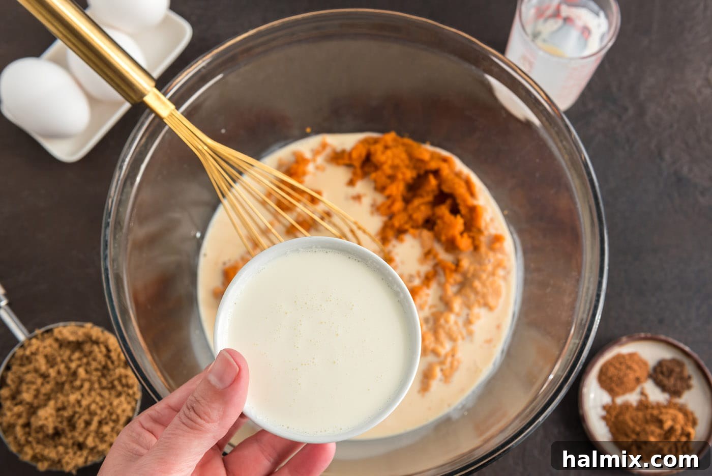 Enchanted Chocolate Pumpkin Cake 7 combining pumpkin pie ingredients in a bowl