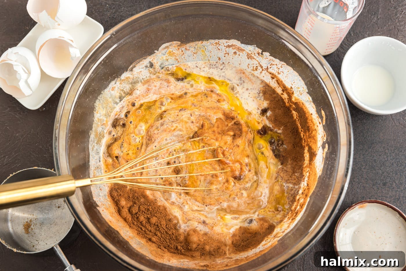Enchanted Chocolate Pumpkin Cake 8 whisking pumpkin pie ingredients together in a bowl