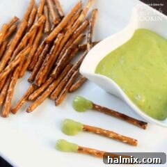 A plate with pretzel sticks, a bowl of boogers (cheese wiz), and boogers on a stick.