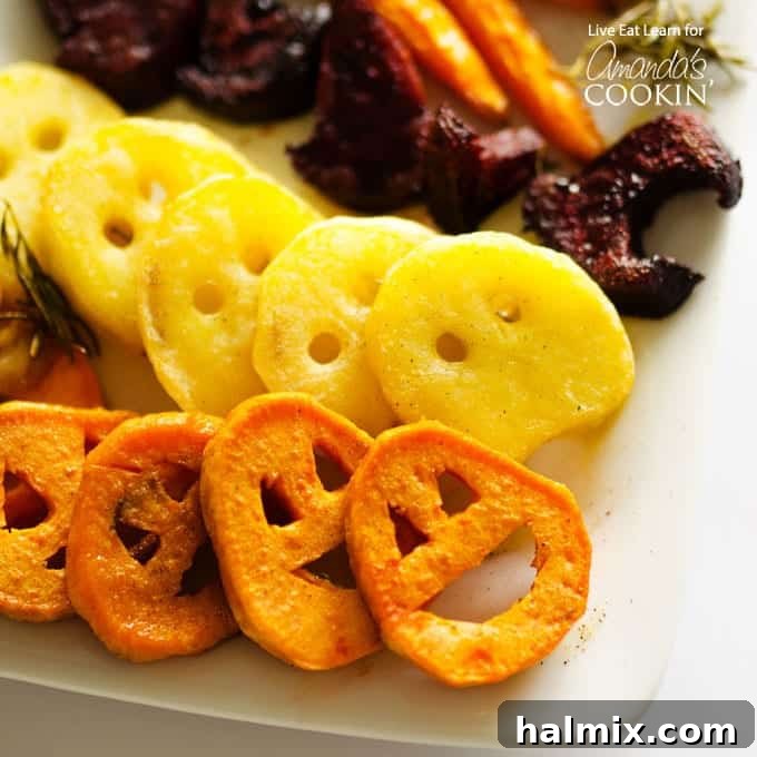 A close up photo of roasted Halloween vegetables artfully arranged on a platter, highlighting the detail of each carved vegetable shape.
