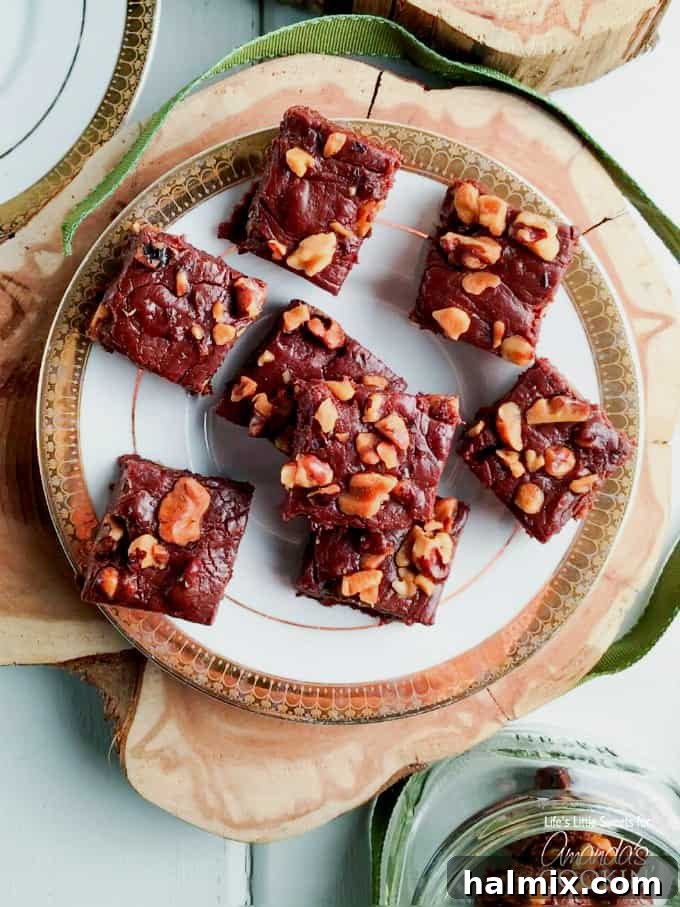 Decadent homemade chocolate walnut fudge squares cooling in a pan.