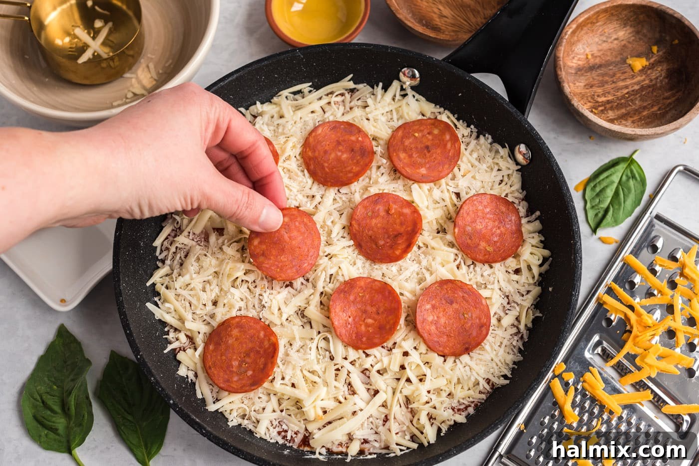 adding pepperoni to pizza dip