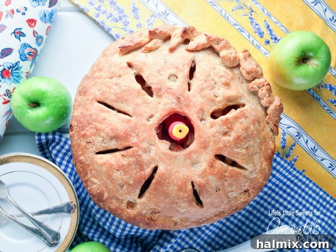 An overhead shot of a whole baked homemade apple pie, showing the beautifully crimped crust.