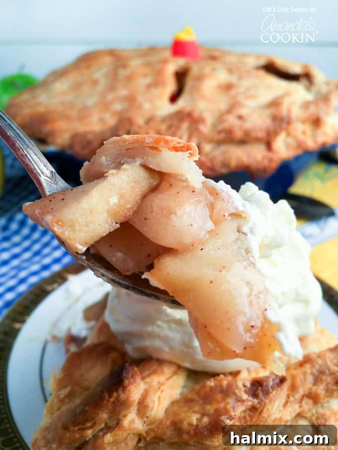 Homemade apple pie recipe ingredients laid out on a table, including sliced apples, sugars, and spices.