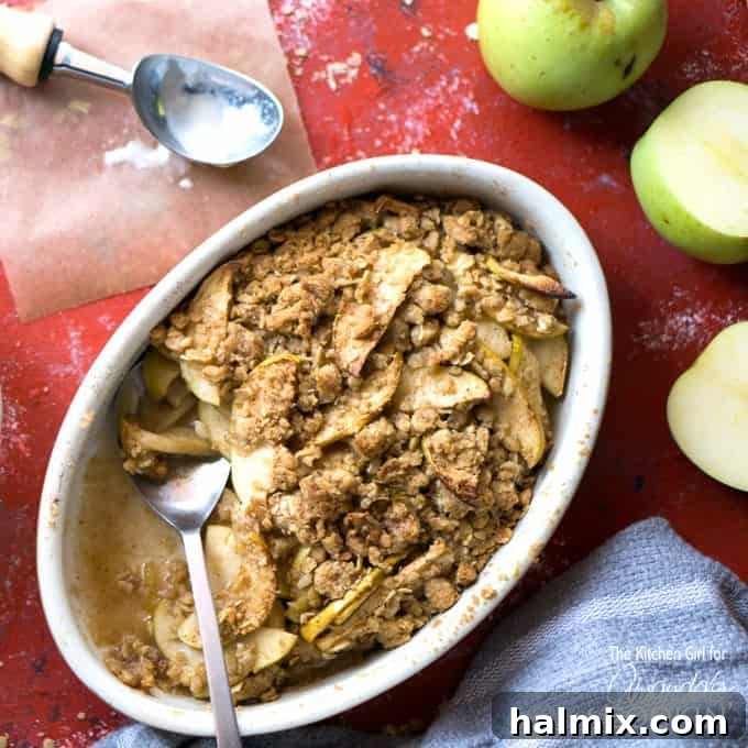A bowl of apple crisp with a spoon, highlighting another delicious apple dessert option.