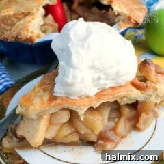 A perfectly baked homemade apple pie with a beautifully crimped crust, ready to be sliced.