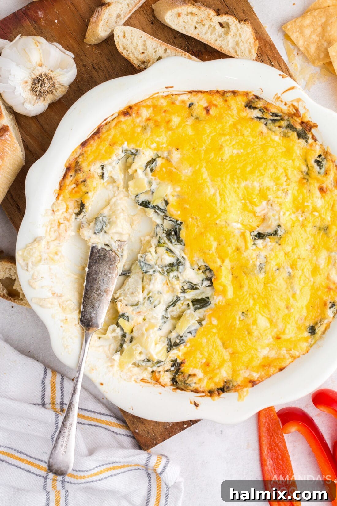 dish of hot spinach dip with some taken out