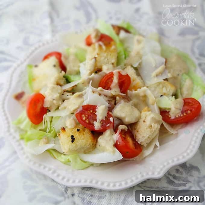 Tomato Caesar Salad, showing a full view of the salad with croutons and bacon.