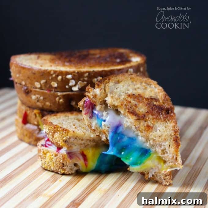 Discover the joy of a Rainbow Grilled Cheese Sandwich, featuring beautifully melted, multicolored cheese inside. Close-up of a Rainbow Grilled Cheese Sandwich with multicolored cheese, showing off its vibrant layers.