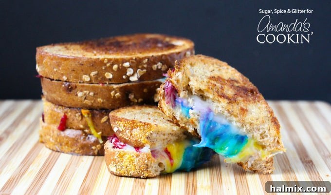 Enjoy this delightful Rainbow Grilled Cheese Sandwich, a colorful twist on a classic comfort food. A freshly made, cut Rainbow Grilled Cheese Sandwich, showing off its colorful melted cheese layers.