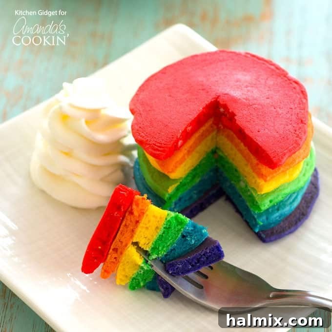 Preparing the batter for rainbow pancakes, showing the various colored mixtures in small bowls before cooking.