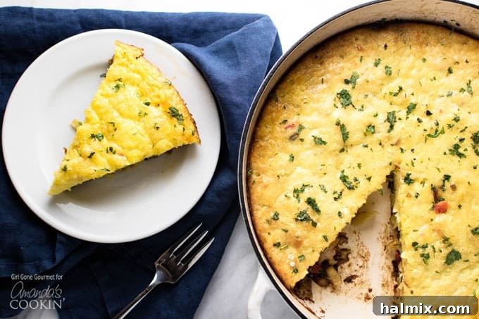A slice of vegetable frittata on a white plate next to the pan of frittata, showing the fluffy interior.