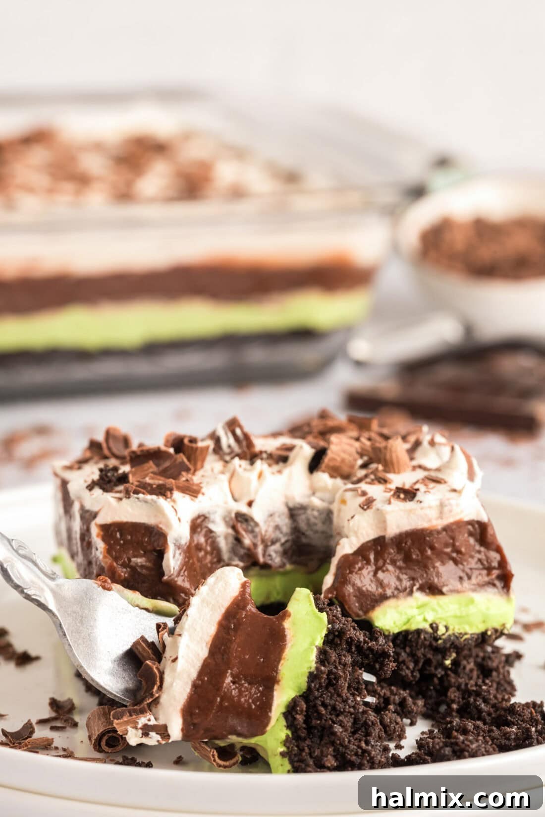 Invigorating Mint Chocolate Lasagna 3 A fork breaking apart a piece of Mint Chocolate Lasagna, revealing its creamy texture