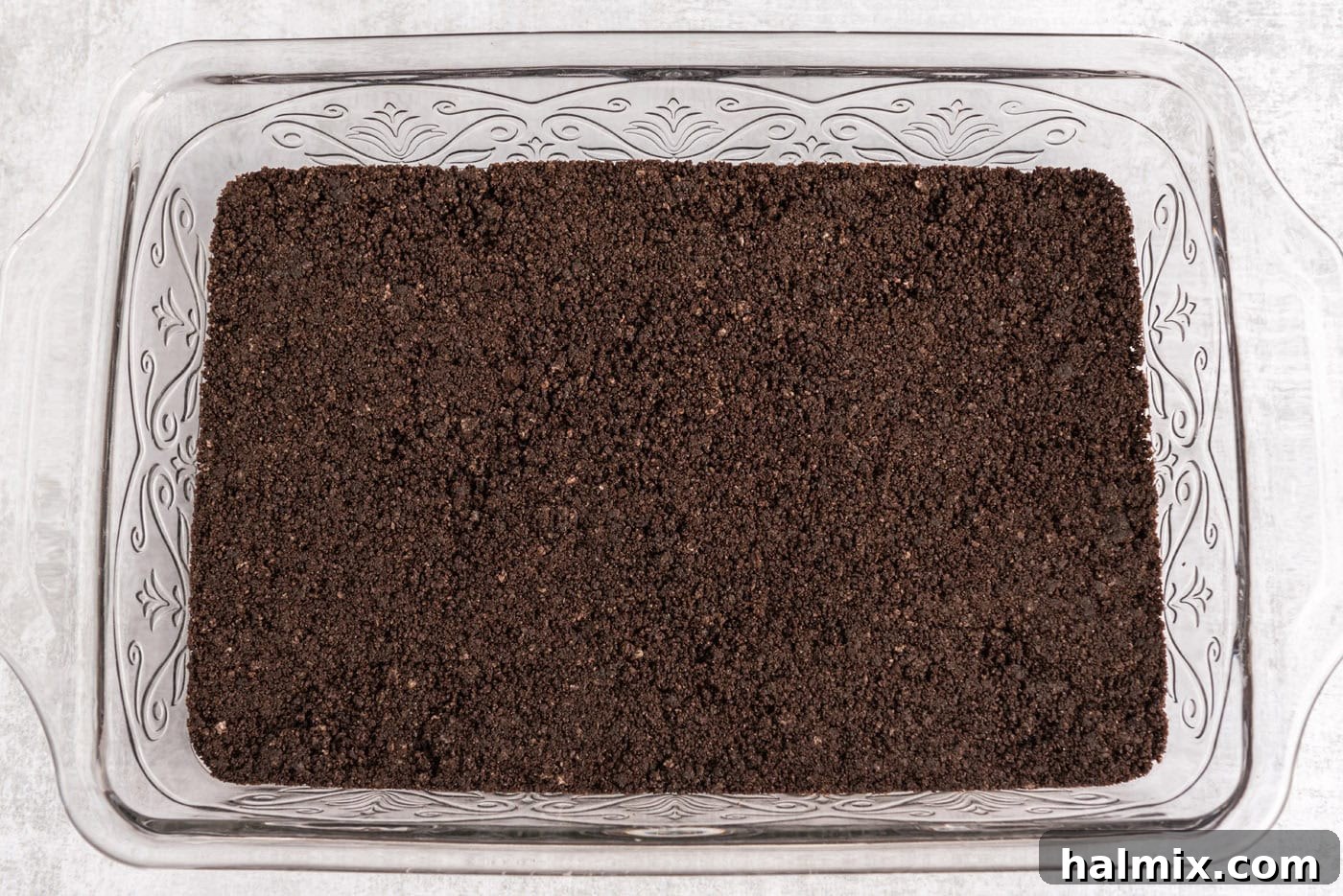 Invigorating Mint Chocolate Lasagna 6 Oreo cookie crust pressed firmly into a baking pan, ready for the next layer