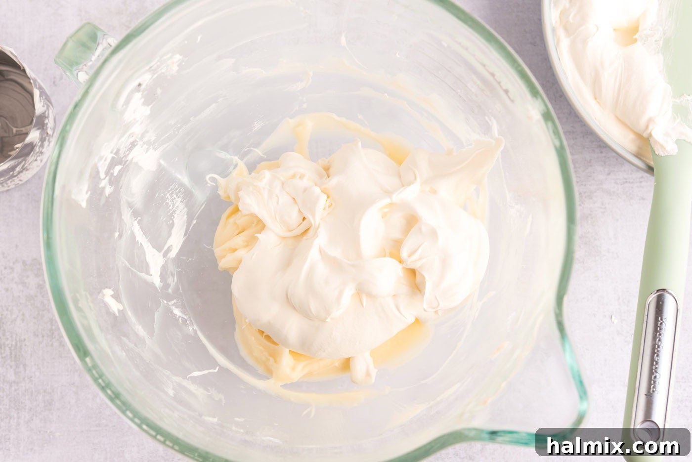 Invigorating Mint Chocolate Lasagna 8 Cool Whip being gently folded into the mint cream cheese mixture