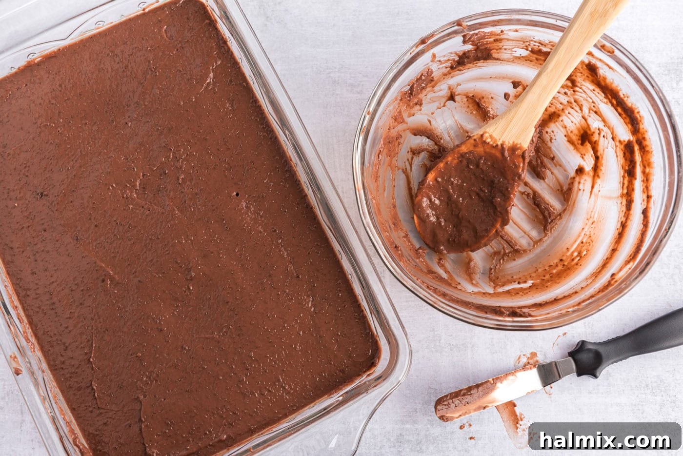 Invigorating Mint Chocolate Lasagna 10 Thick chocolate pudding being poured and spread into a baking dish over the mint layer