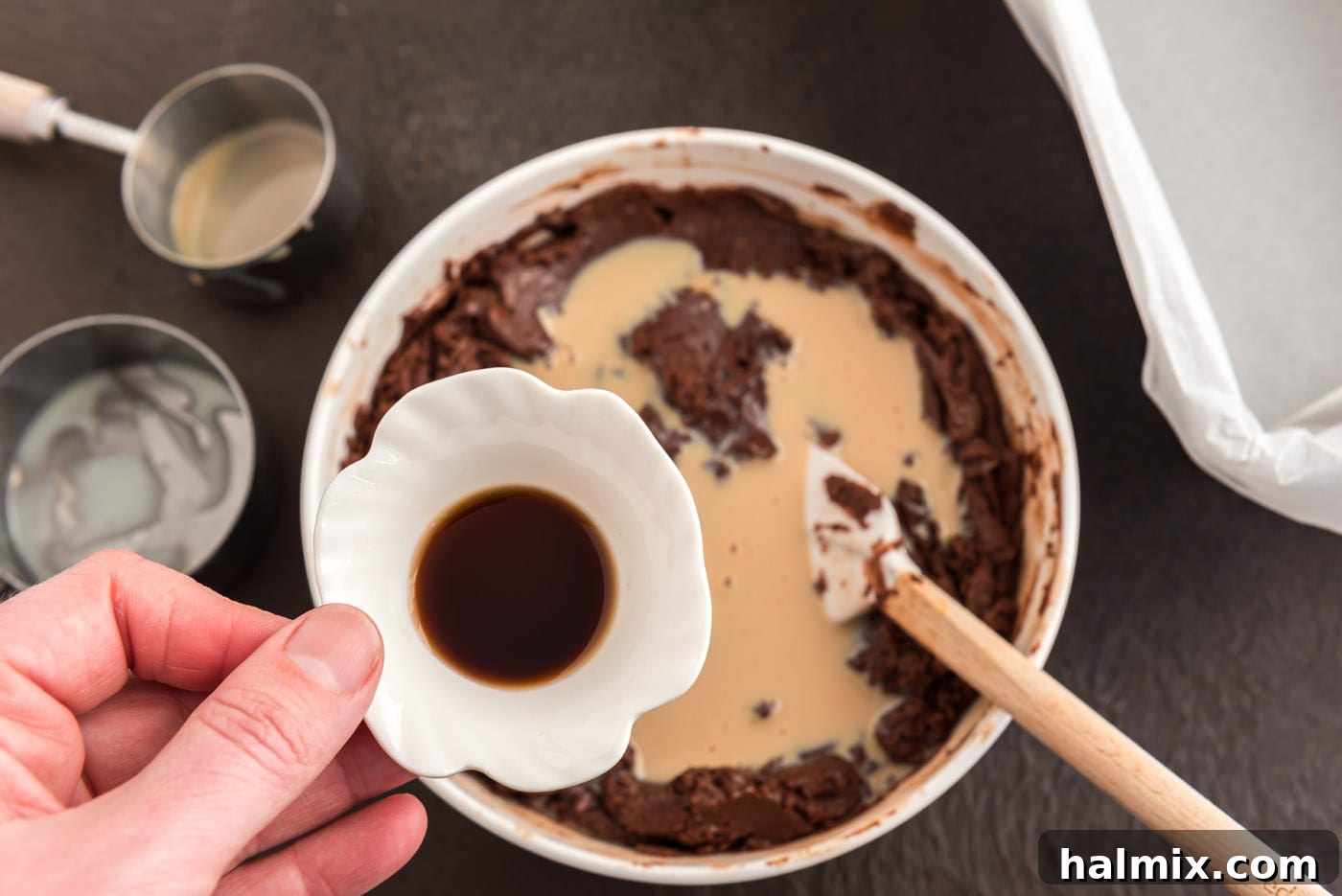 Vanilla extract being added to the Baileys chocolate fudge mixture.