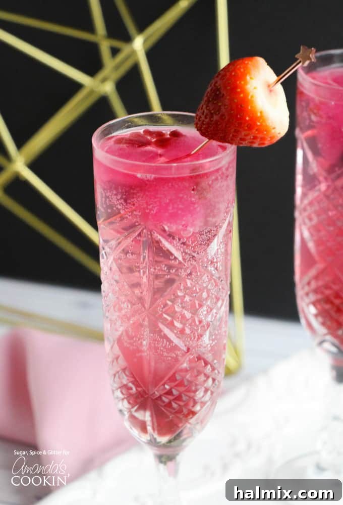 Cupid's Cocktail for Valentine's Day - featuring sparkling champagne with strawberry and pomegranate garnishes.