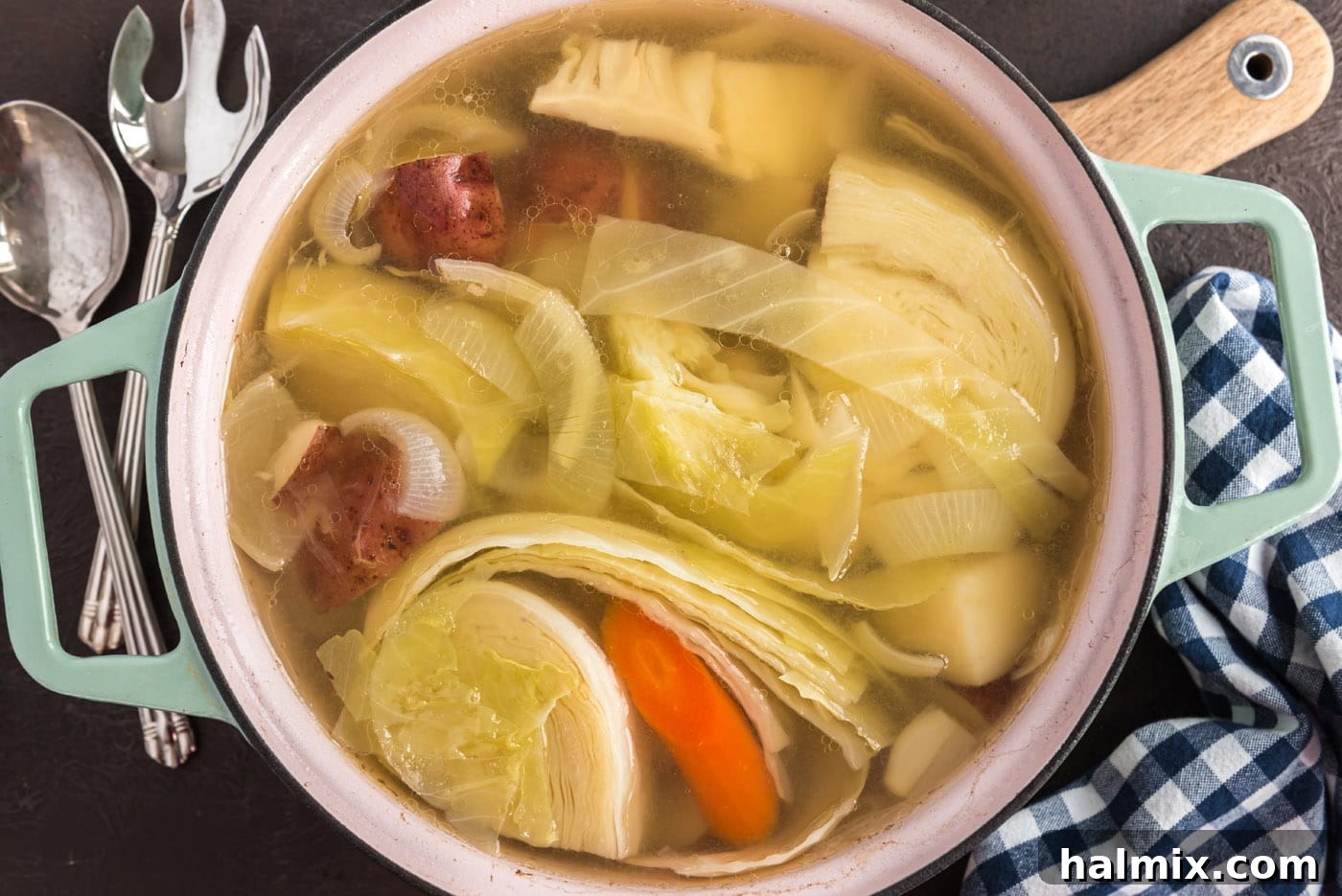 corned beef and cabbage with carrots and onion in a dutch oven