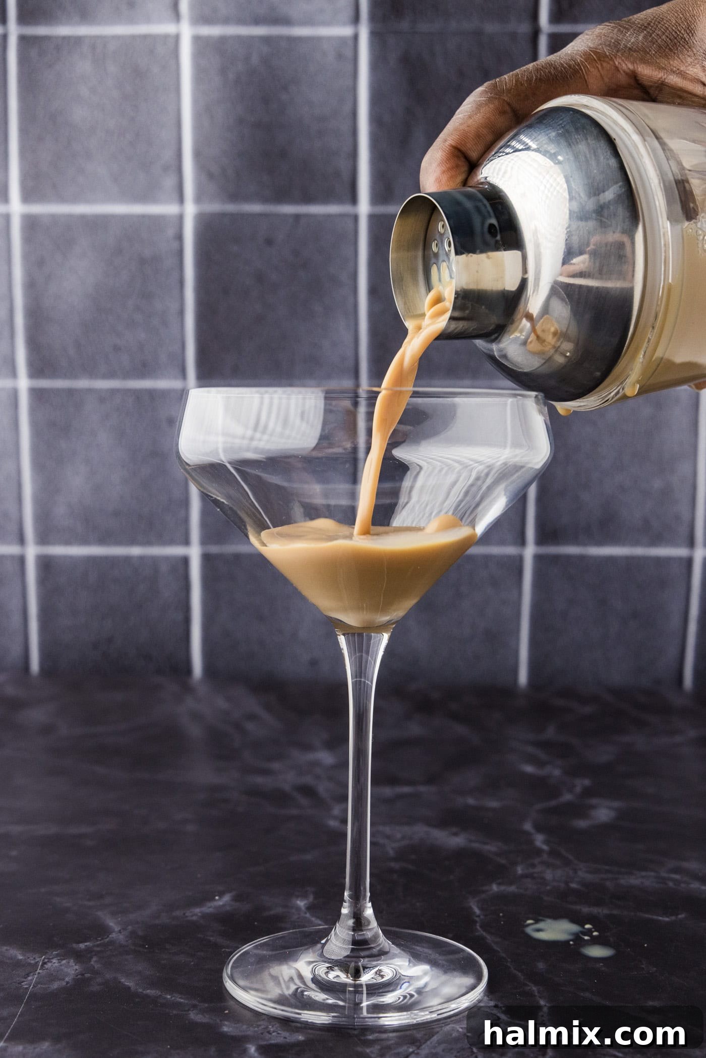 Straining baileys chocolate martini into a glass