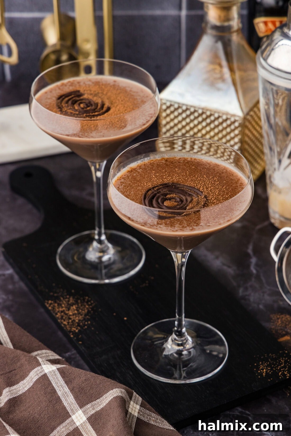 Two Baileys Chocolate Martinis on a black wooden platter