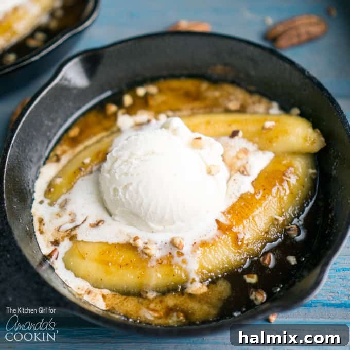A close up of single serve banana foster topped with vanilla ice cream in a 5-inch skillet, showing the melted ice cream and pecans.