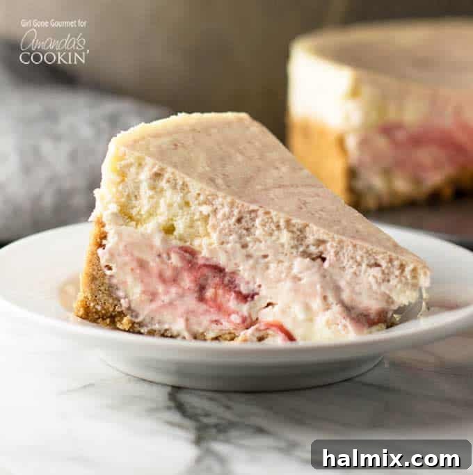 Velvet Strawberry Swirl Cheesecake 3 A perfectly sliced piece of strawberry swirl cheesecake on a white plate, revealing the intricate red fruit swirls.